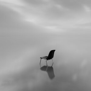greyscale shot chair water surface with reflection rainy day scaled e1728315535945
