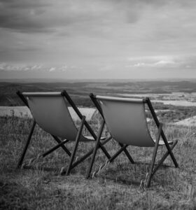 deck chairs field against sky scaled e1730818779706